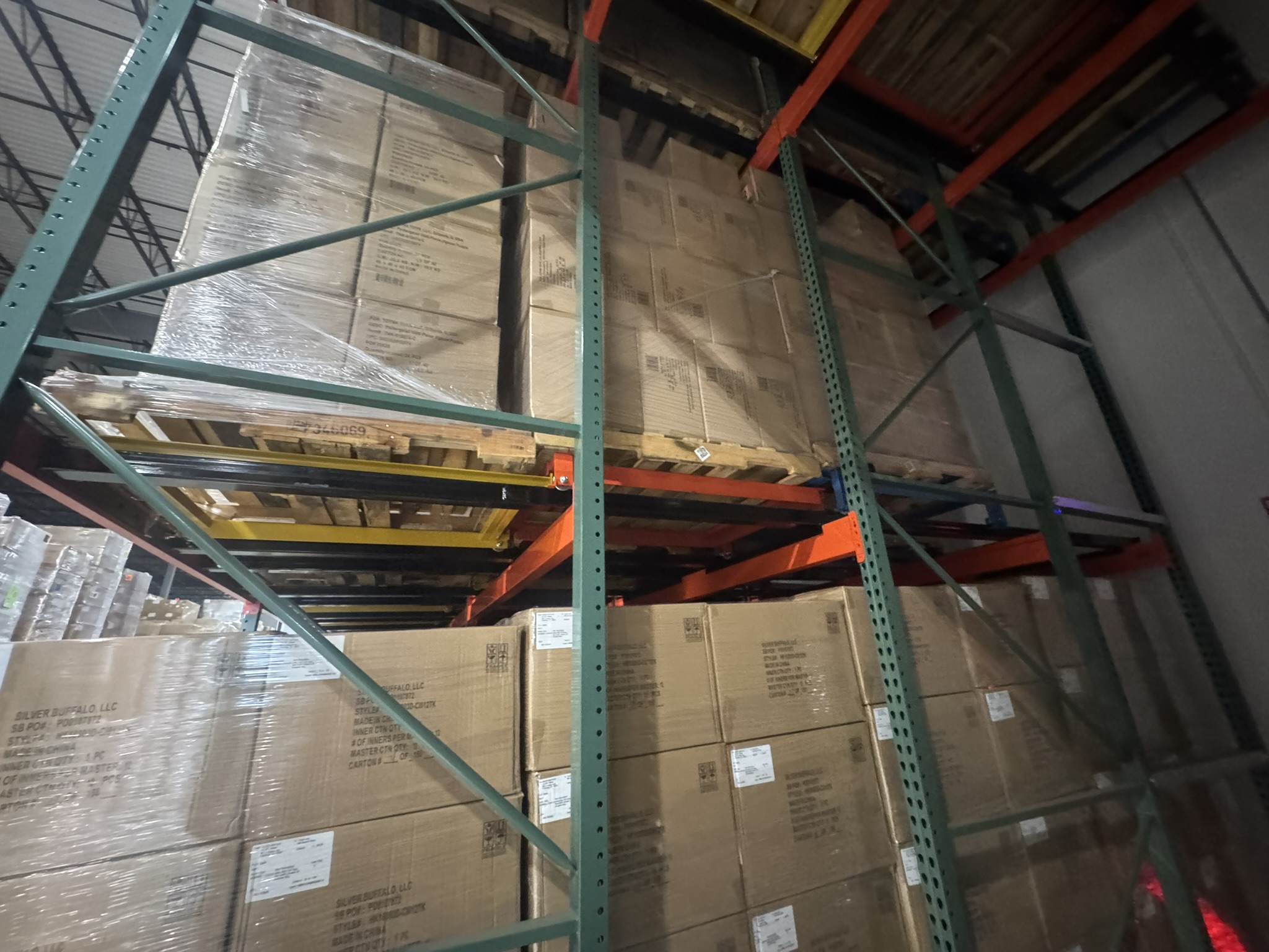 Interior view of push back racking system with nested carts on inclined rails